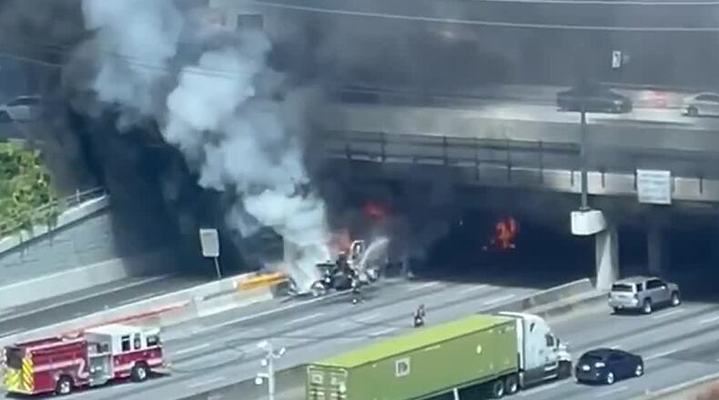 A massive truck fire under the Ashford Dunwoody Road bridge shut down all lanes of I-285 on Monday.