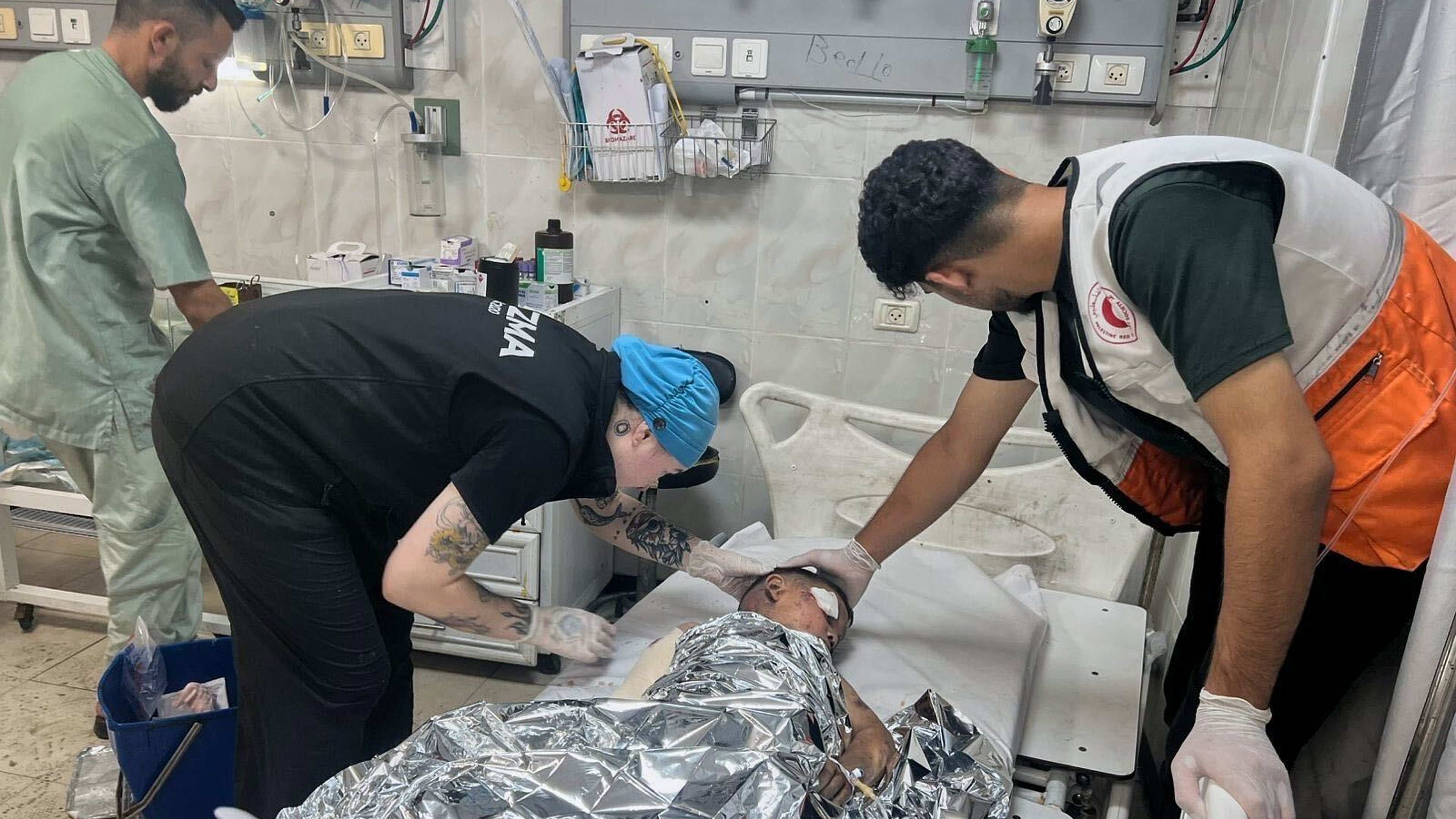 This photo provided by American nurse Andee Vaughan, second from left, shows Vaughan attending to a child suffering from severe burns after an Israeli army strike on his house, at the Al-Quds Hospital in Gaza City on July 24, 2025. (Courtesy Andee Vaughan via AP)