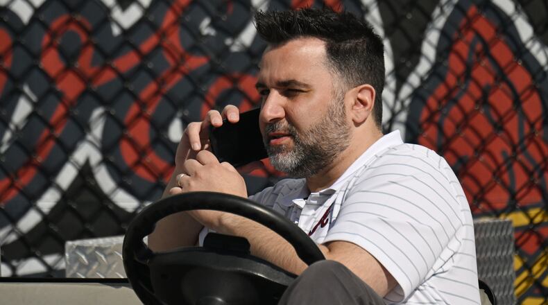 Atlanta Braves general manager Alex Anthopoulos talks on the phone during spring training workouts at CoolToday Park, Wednesday, Feb. 21, 2024, in North Port, Florida. (Hyosub Shin / Hyosub.Shin@ajc.com)
