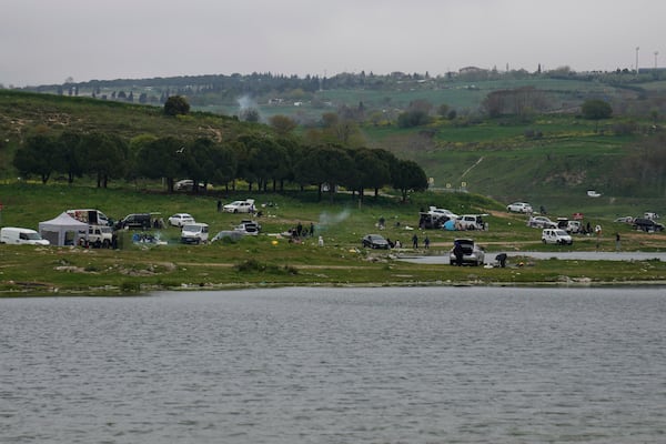 People gather outdoors away from urban areas following an earthquake shock with a preliminary magnitude of 6.2, in Istanbul, Turkey, Wednesday, April 23, 2025. (AP Photo/Khalil Hamra)