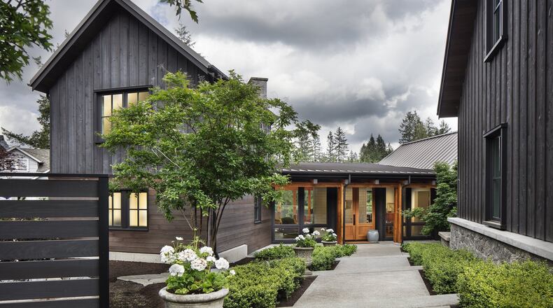 Cathy and John s home sits four feet lower than the road. The garage is square with the street, and the house is turned, says John. Angled stairs bring it all together. (Steve Ringman/The Seattle Times/TNS)
