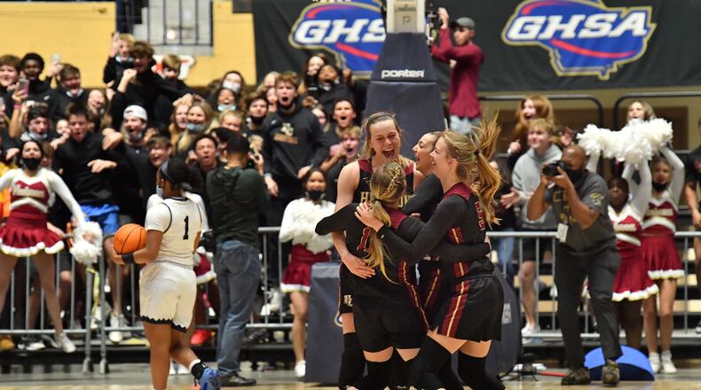 Hebron Christian players celebrate clinching the Class A Private championship Wednesday, March 10, 2021, at the Macon Centreplex in Macon. The Hebron Christian girls defeated St. Francis 51-46 in overtime. (Hyosub Shin / Hyosub.Shin@ajc.com)