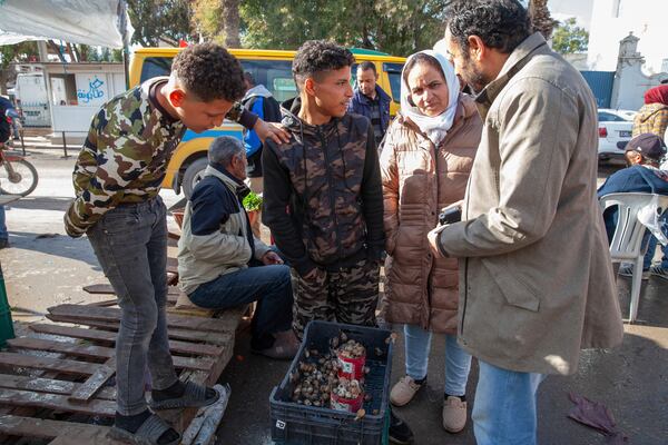 Customers buy snails at a weekly market in Enfidha, Tunisia, March 27, 2025. (AP Photo/Ons Abid)