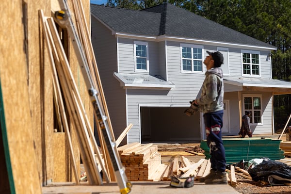 Workers build a single-family home in a development in South DeKalb on Thursday, March 20, 2025. (Arvin Temkar/AJC)