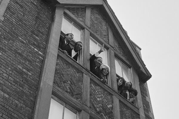 FILE - Dr. Martin Luther King, Jr. and his wife Coretta Scott King wave to crowd in street from center window of a third-floor walk-up apartment he rented on Chicago's West Side, Jan. 26, 1966. (AP Photo/Edward Kitch, File)
