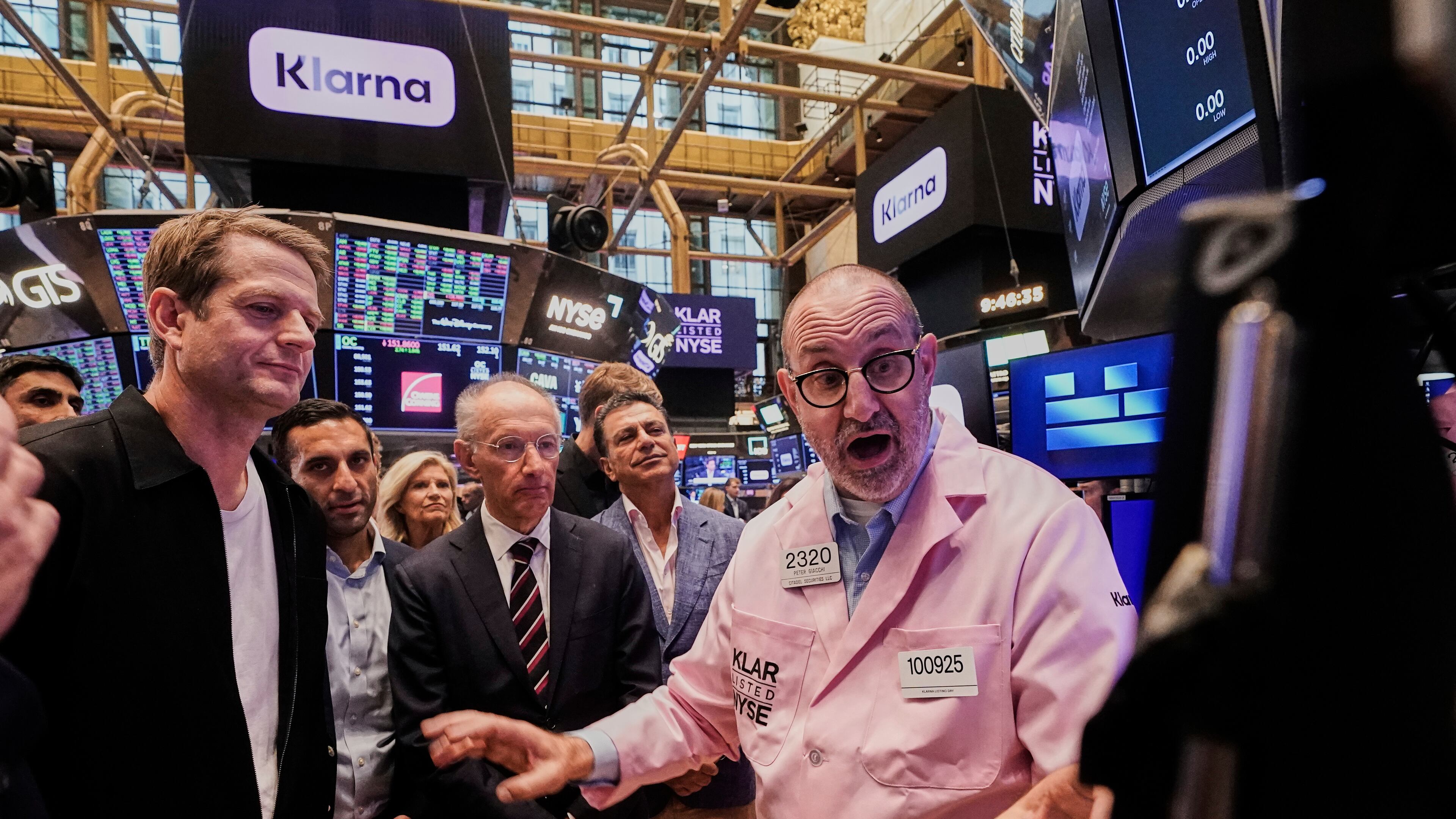 Klarna CEO Sebastian Siemiatkowski, left and company Chairman Michael Moritz, center, meet with specialist Peter Giacchi, right, before their IPO begins trading on the floor of the New York Stock Exchange, Wednesday, Sept. 10, 2025. (AP Photo/Richard Drew)