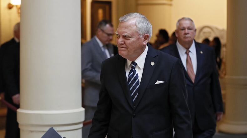 Gov. Nathan Deal, followed by House Speaker David Ralston, heads to a press conference where he and legislative leaders announced Tuesday a compromise plan for dealing with the massive state windfall created by the federal tax law, calling for a reduction in the state income tax rate and an increase in the standard deduction. BOB ANDRES /BANDRES@AJC.COM