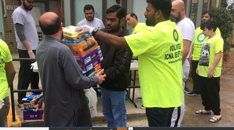 Volunteers at the Islamic Circle of North America pack boxes of food for those in need, including senior citizens, people with compromised immune systems and children who are out of school. CONTRIBUTED