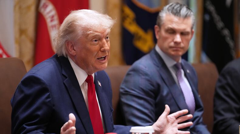 President Donald Trump speaks during a Cabinet meeting at the White House, Wednesday, May 27, 2026, in Washington, as Secretary of Defense Pete Hegseth, looks on. (AP Photo/Jacquelyn Martin)