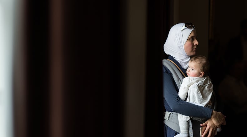 Hiba Tinawi, from Syria, holds her 6-month-old daughter Judy during an event to welcome Syrian refugee families who have recently resettled in the city of Clarkston, Saturday, Dec. 12, 2015, Clarkston, Ga. BRANDEN CAMP/SPECIAL