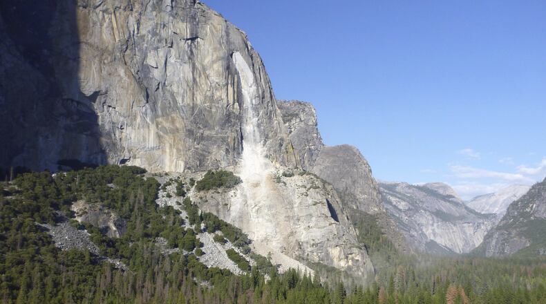 This Thursday, Sept. 28, 2017 photo provided by The National Park Service shows a rock fall off the iconic El Capitan rock formation in Yosemite National Park, Calif. A massive new rock fall hit Yosemite National Park on Thursday, cracking with a thundering roar off the iconic El Capitan rock formation and sending huge plumes of white dust surging through the valley floor below. (The National Park Service via AP)