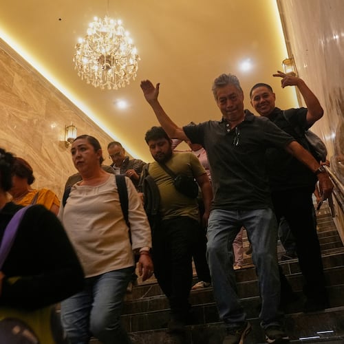 People walk through a subway station that has new lighting, part of preparations for hosting the World Cup soccer tournament in Mexico City, Wednesday, June 10, 2026. (AP Photo/Marco Ugarte)