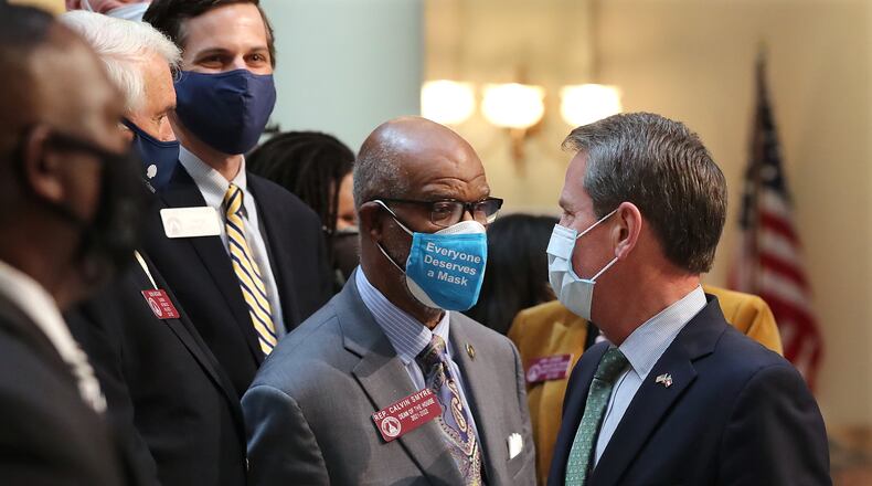 021621 Atlanta: Governor Brian Kemp (right) confers with Rep. Calvin Smyre (left), Dean of the House, during a press conference announcing the overhaul of Georgia’s citizen’s arrest statute at the capitol on Tuesday, Feb 16, 2021, in Atlanta. Curtis Compton / Curtis.Compton@ajc.com”