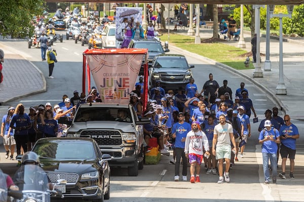 Parade participants head down Capitol Ave. on their way to Centennial Park during the Juneteenth Atlanta Parade and Music Festival Saturday, June 17, 2023.   (Steve Schaefer/AJC)