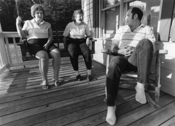 Mike Dobbins chats with his daughter, Angie, and his wife, Jane, on the porch of the family’s Adairsville home. Before the couple adopted Angie, she spent years in foster care. (Johnny Crawford / AJC Photo Archive at GSU Library AJCP164-042d)