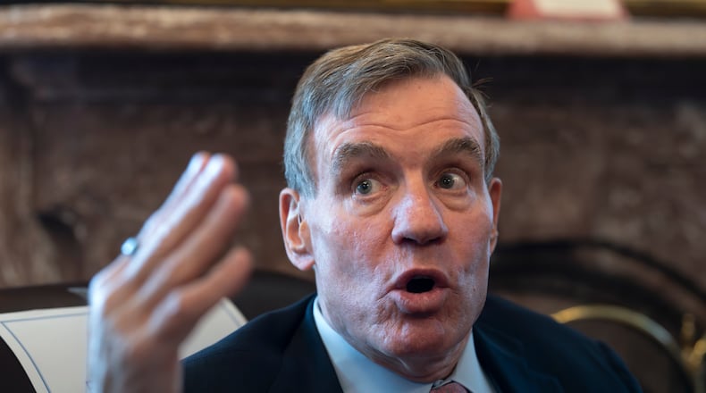 Sen. Mark Warner, D-Va., the vice chair of the Senate Intelligence Committee, speaks to reporters about FISA, the law that allows the U.S. to gather intelligence abroad, at the Capitol in Washington, Thursday, June 11, 2026. (AP Photo/J. Scott Applewhite)