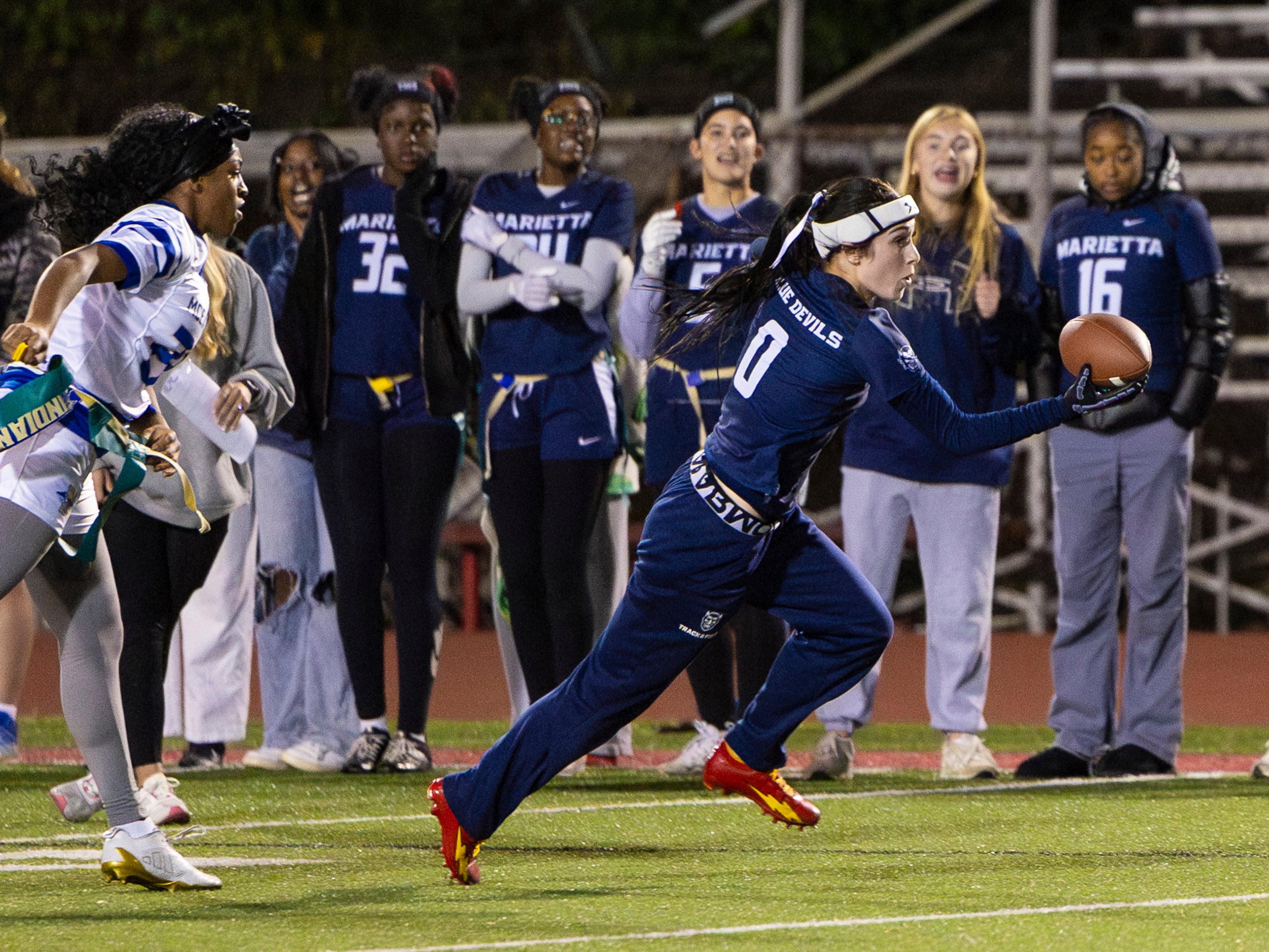 Marietta's Aksana Corey (left) runs with the ball in a flag football game against McEachern at Osborne High School in Marietta, GA on Monday, November 17th, 2025. (Oscar Guevara Saenz for the AJC)