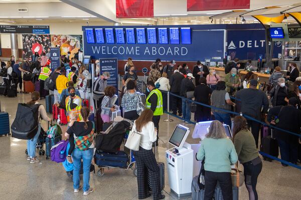 People wait in line at the Delta check-in at the South Terminal at Hartsfield-Jackson International Airport on Monday,  December 27, 2021. STEVE SCHAEFER FOR THE ATLANTA JOURNAL-CONSTITUTION