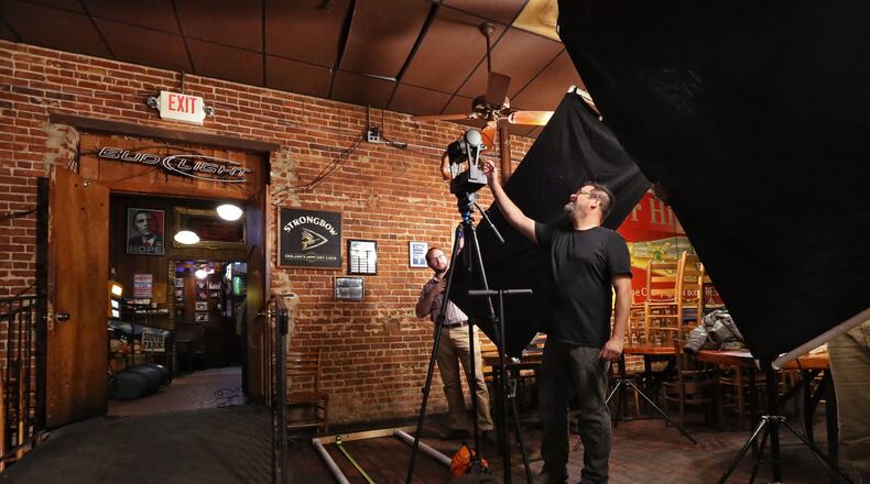 Michael Page, a lecturer at Emory University, prepares to photograph a wall at Manuel’s Tavern using the GigaPan system. Page, along with Ruth Dusseault of Georgia State University and other scholars and volunteers, are documenting the interior of Manuel’s Tavern before it goes through a major renovation. BOB ANDRES / BANDRES@AJC.COM