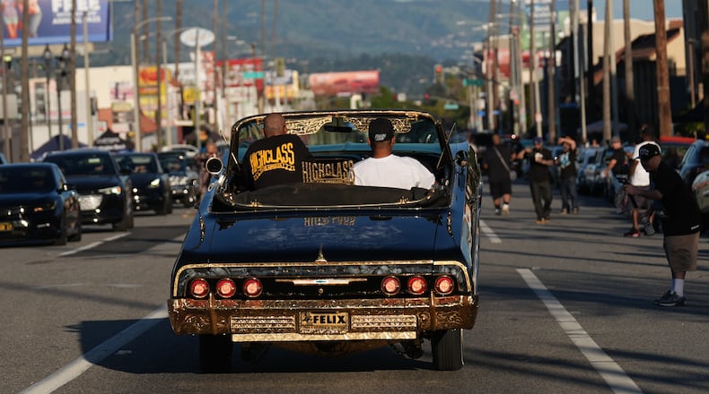 Lowriders cruise at the 6th Annual Lady Lowrider Cruise Night in celebration of International Women's Day in Pasadena, Calif., on Sunday, March 8, 2026. (AP Photo/Damian Dovarganes)