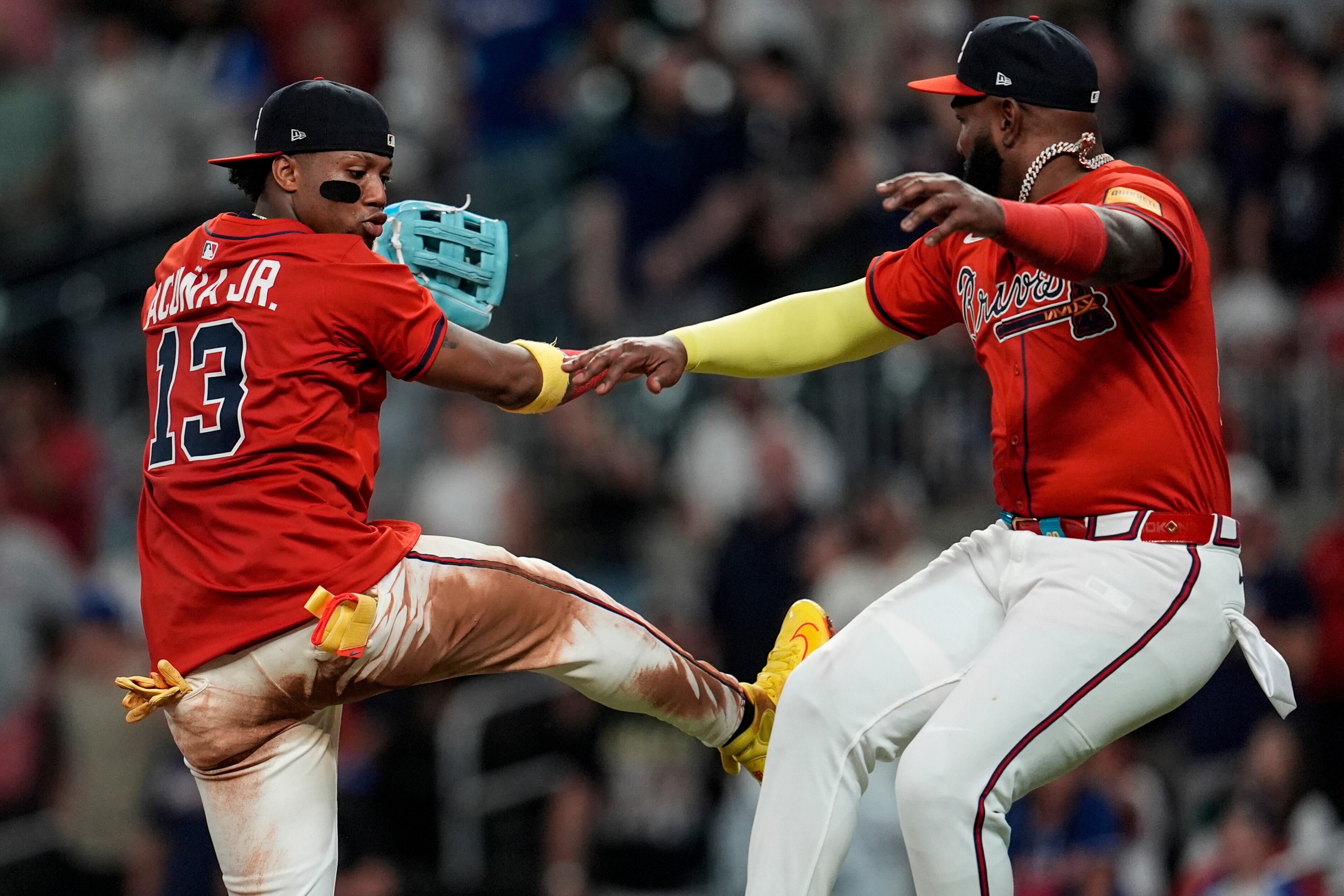 The Braves' Ronald Acuña Jr. (left) and Marcell Ozuna celebrate victory over the Colorado Rockies on Friday in Atlanta. (Mike Stewart/AP)