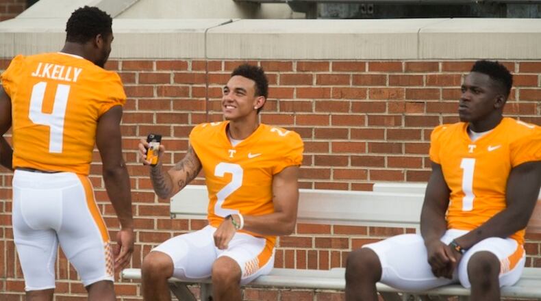 From left toright, running back John Kelly (4), quarterback Jarrett Guarantano (2) and defensive lineman Jonathan Kongbo (1) wait for group photographs during NCAA college football media day in Knoxville, Tenn., Sunday, Aug. 13, 2017. (Saul Young/Knoxville News Sentinel via AP)