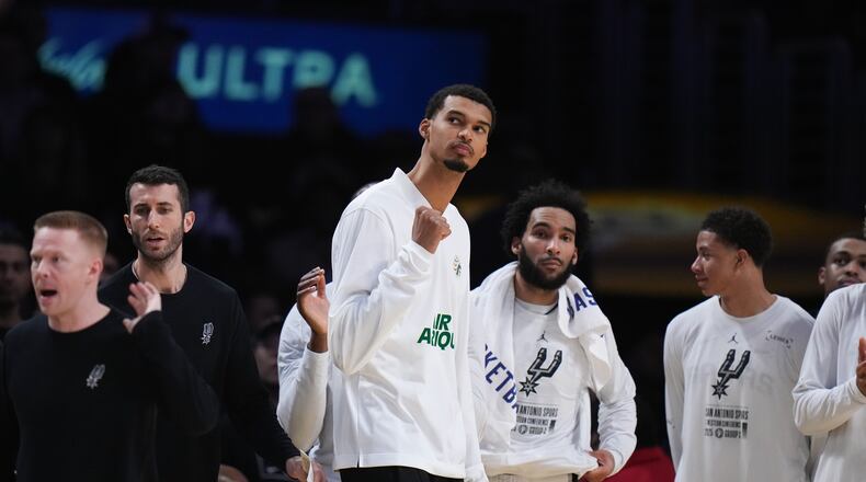 San Antonio Spurs' Victor Wembanyama, center, reacts to a play during the second half of an NBA Cup basketball game against the Los Angeles Lakers Wednesday, Dec. 10, 2025, in Los Angeles. (AP Photo/Jae C. Hong)