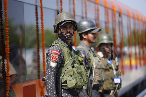 Security personnel stand guard next to Vande Bharat Express train to run between Srinagar and Katra, which is soon to be inaugurated, in Srinagar, Indian controlled Kashmir, Friday, June 6, 2025. (AP Photo/Dar Yasin)