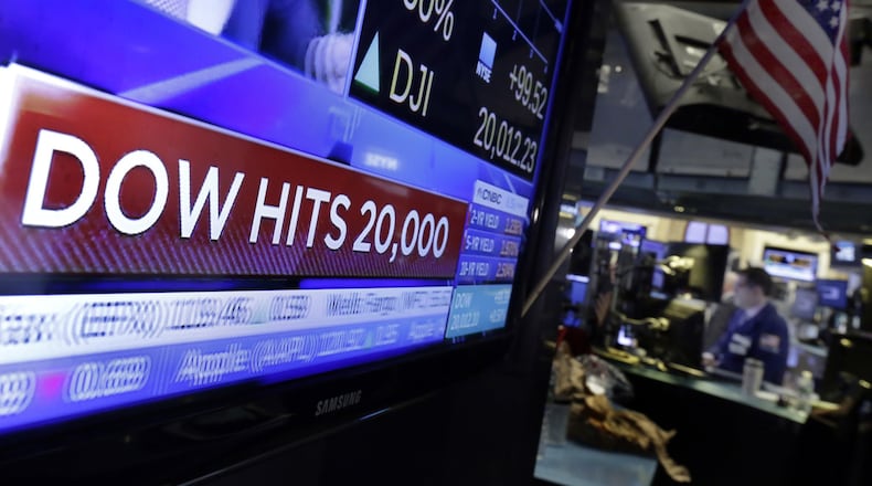 A television screen displays the news Wednesday as the Dow broke 20,000. The index of 30 leading stocks has tripled in the past eight years. (AP Photo/Richard Drew)