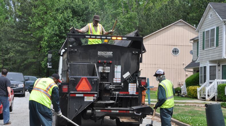DeKalb County workers fill a pothole. A proposed 1 percent sales tax would help pay for road repaving and other infrastructure.
