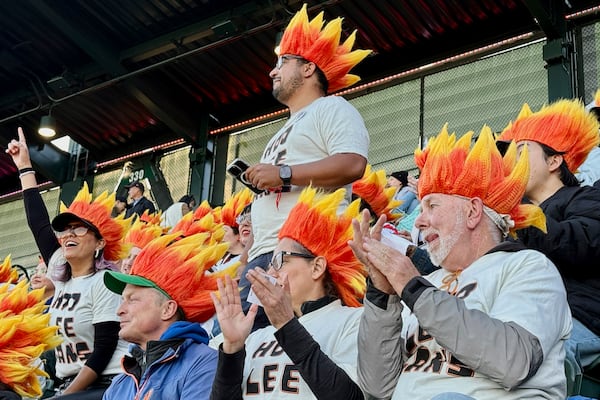 Fans of San Francisco Giants' Jung Hoo Lee, who call themselves Hoo Lee Gans, watch during a baseball game between the Giants and the Arizona Diamondbacks in San Francisco, Tuesday, May 13, 2025. (AP Photo/Haven Daley)