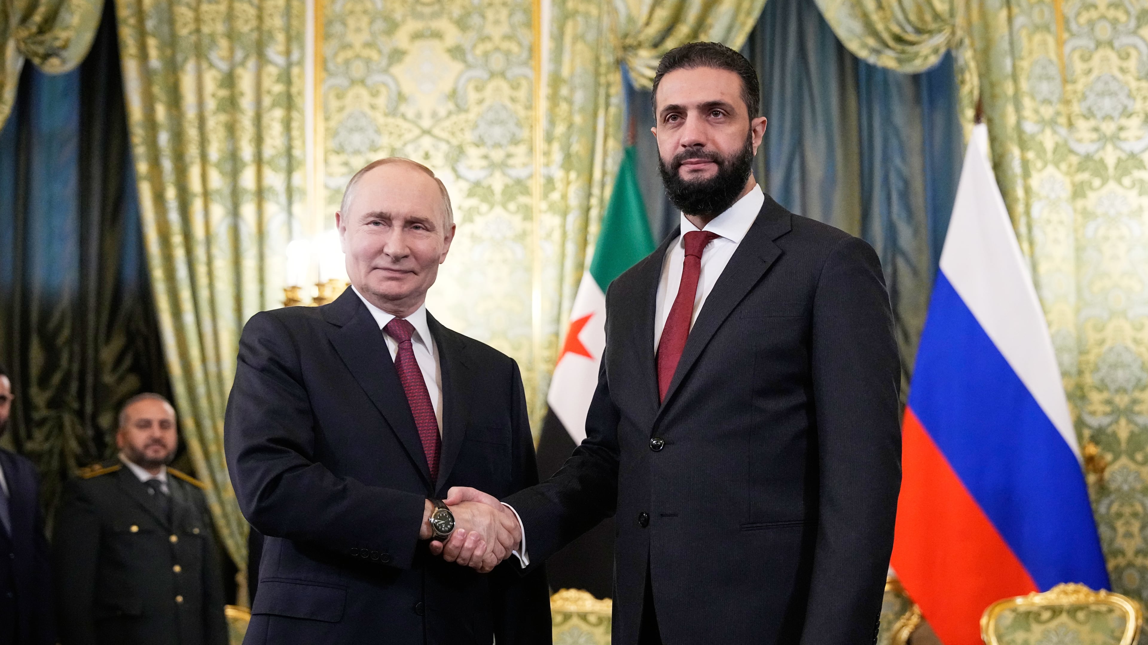 Russian President Vladimir Putin, left, and Syrian interim President Ahmad al-Sharaa shake hands during their meeting at the Grand Kremlin Palace in Moscow, Russia, Wednesday, Oct. 15, 2025. (AP Photo/Alexander Zemlianichenko, Pool)
