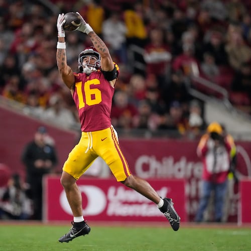 Southern California wide receiver Tanook Hines catches a pass thrown by punter Sam Johnson during the first half of an NCAA college football game against Northwestern, Friday, Nov. 7, 2025, in Los Angeles. (AP Photo/Mark J. Terrill)