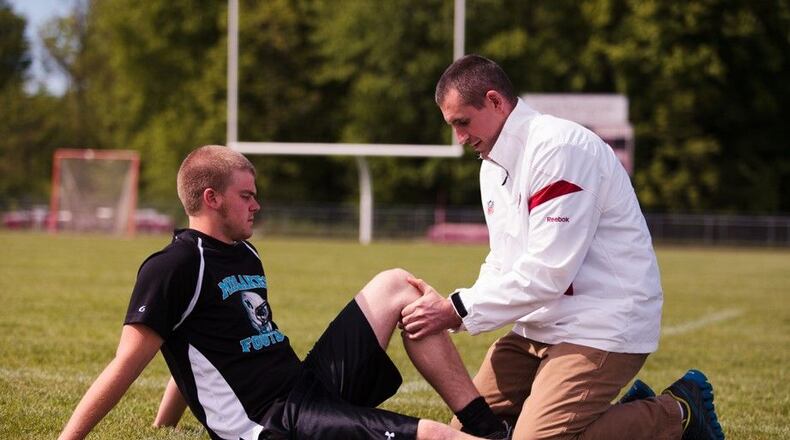 Dr. Christopher Brown works on an injured athlete.