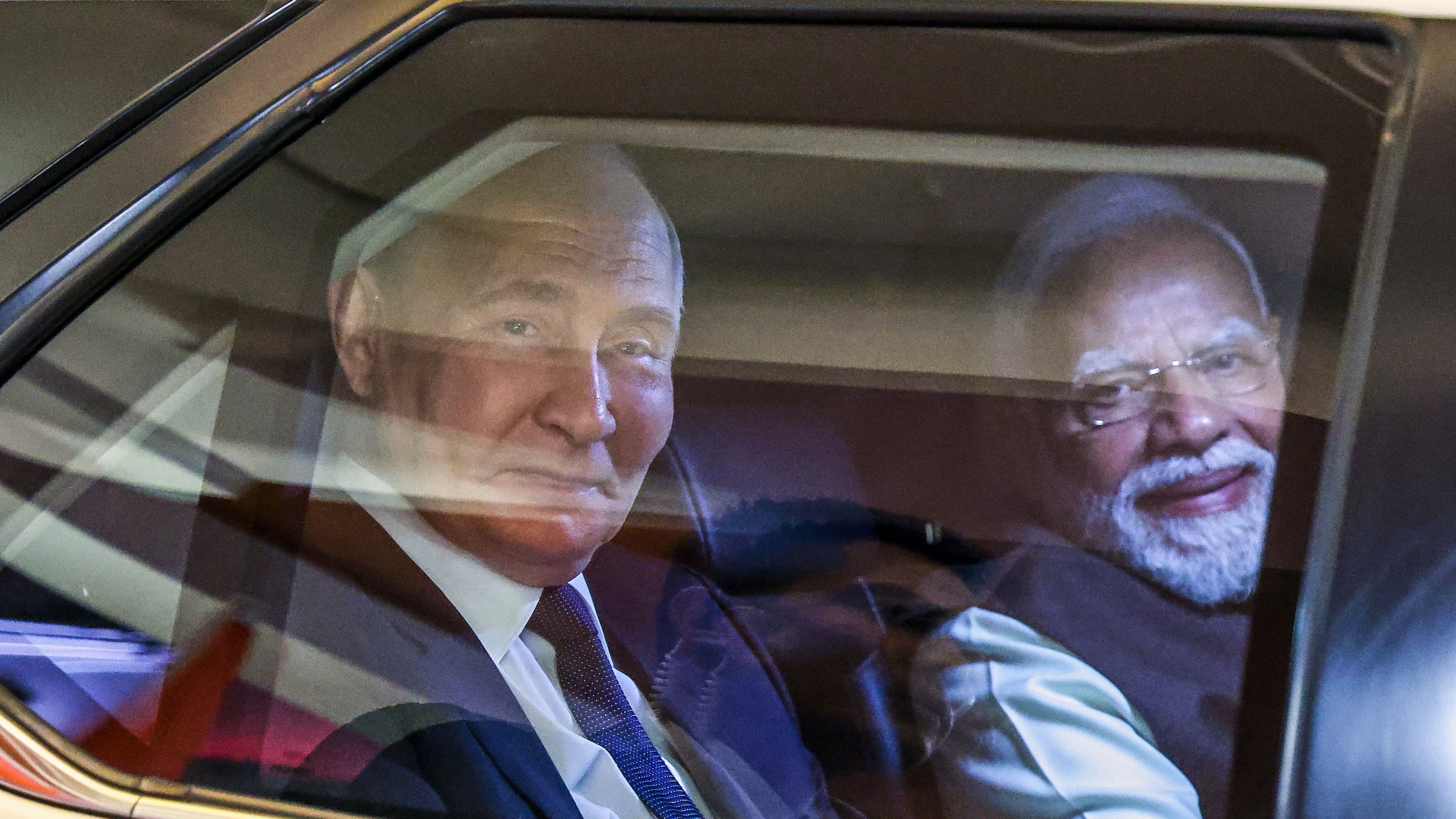 Russian President Vladimir Putin, left, and Indian Prime Minister Narendra Modi sit inside a limousine as they arrive at the Indian Prime Minister office in New Delhi, India, on Thursday, Dec. 4, 2025. (Alexander Kazakov, Sputnik, Kremlin Pool Photo via AP)