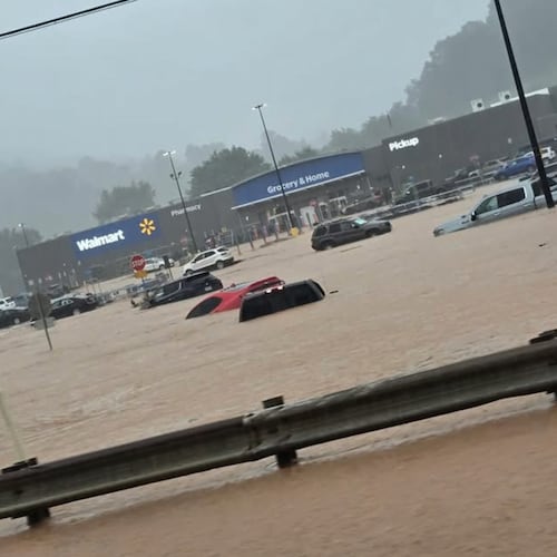 In this photo provided by Alexis Wood, a flooded Walmart parking lot is shown Tuesday, July 21, 2026, in Weston, W.Va. (Alexis Wood via AP)