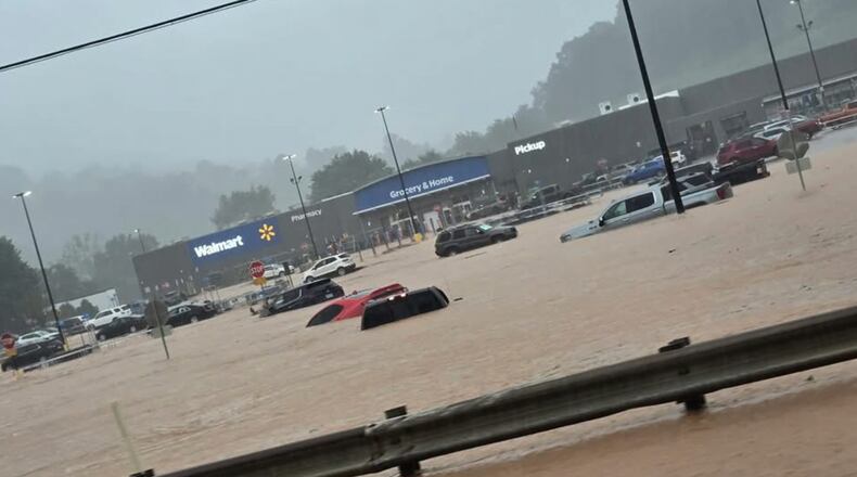 In this photo provided by Alexis Wood, a flooded Walmart parking lot is shown Tuesday, July 21, 2026, in Weston, W.Va. (Alexis Wood via AP)