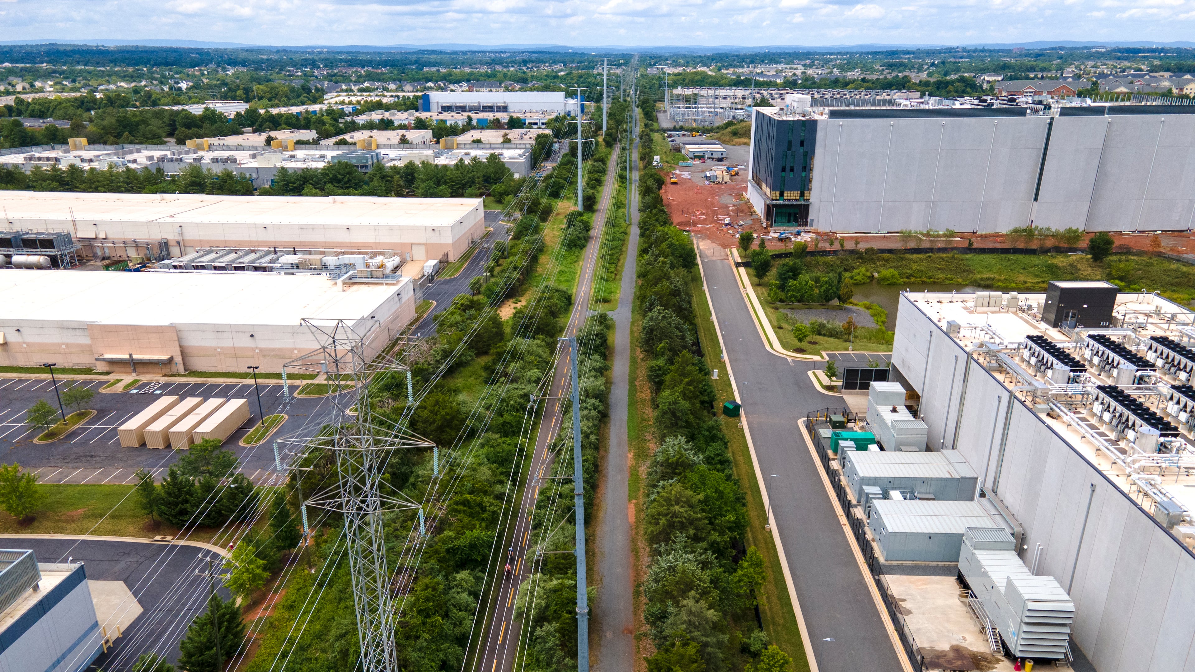FILE - High-voltage transmission lines provide electricity to data centers in Ashburn in Loudon County, Virginia, on Sunday, July 16, 2023. (AP Photo/Ted Shaffrey, File)