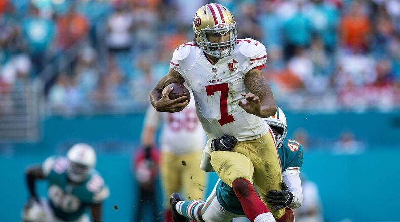 San Francisco 49ers quarterback Colin Kaepernick (7), runs through the tackle by Miami Dolphins cornerback Byron Maxwell (41) on November 27, 2016 at Hard Rock Stadium in Miami Gardens. (Bill Ingram / The Palm Beach Post)