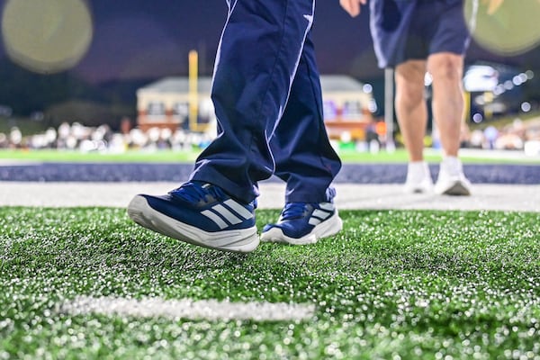 Georgia Southern University President Kyle Marrero’s shoes carry him more than 12,000 steps around Allen E. Paulson stadium during home games. (Sarah Peacock for the AJC)
