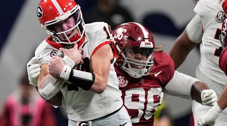 FILE Georgia quarterback Gunner Stockton (14) runs against Alabama during the second half of a Southeastern Conference championship NCAA college football game, Saturday, Dec. 6, 2025, in Atlanta. (AP Photo/Mike Stewart, File)