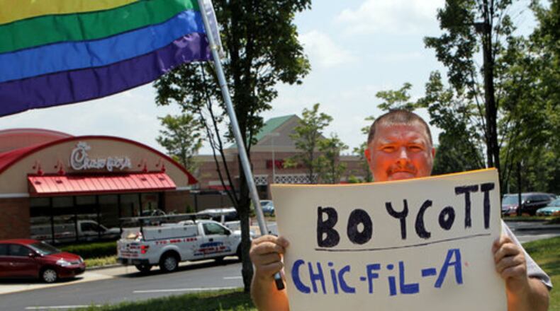Lone protestor Dwayne Tatum marches in front of people how jammed the Chick-fil-A in Sandy Springs on Mount Vernon Highway.