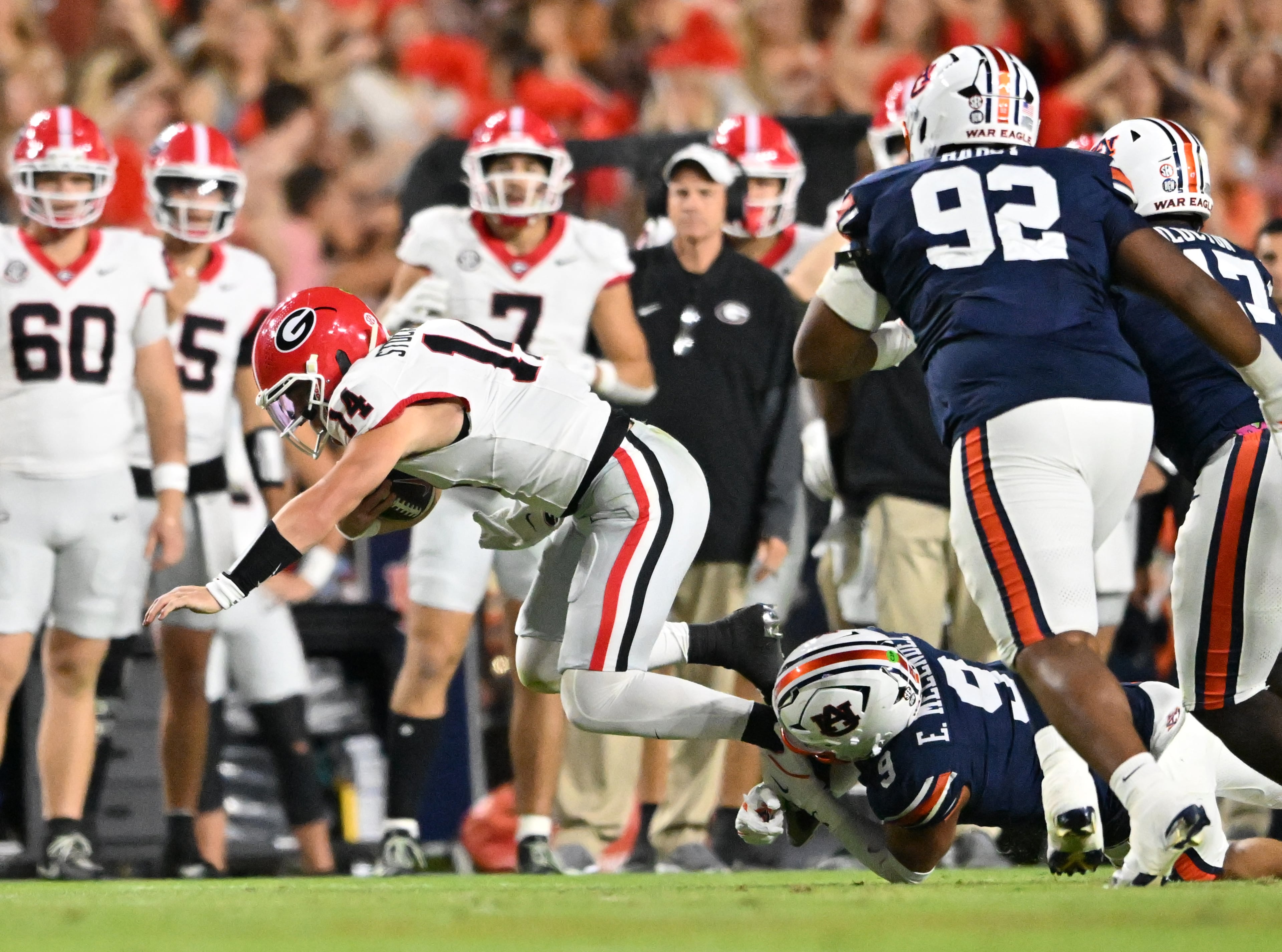 Georgia quarterback Gunner Stockton (14) gets tackled from behind by Auburn linebacker Elijah Melendez (9) during the first half in a NCAA college football game at Jordan-Hare Stadium, Saturday, October 11, 2025, in Auburn, Ala. (Hyosub Shin / AJC)