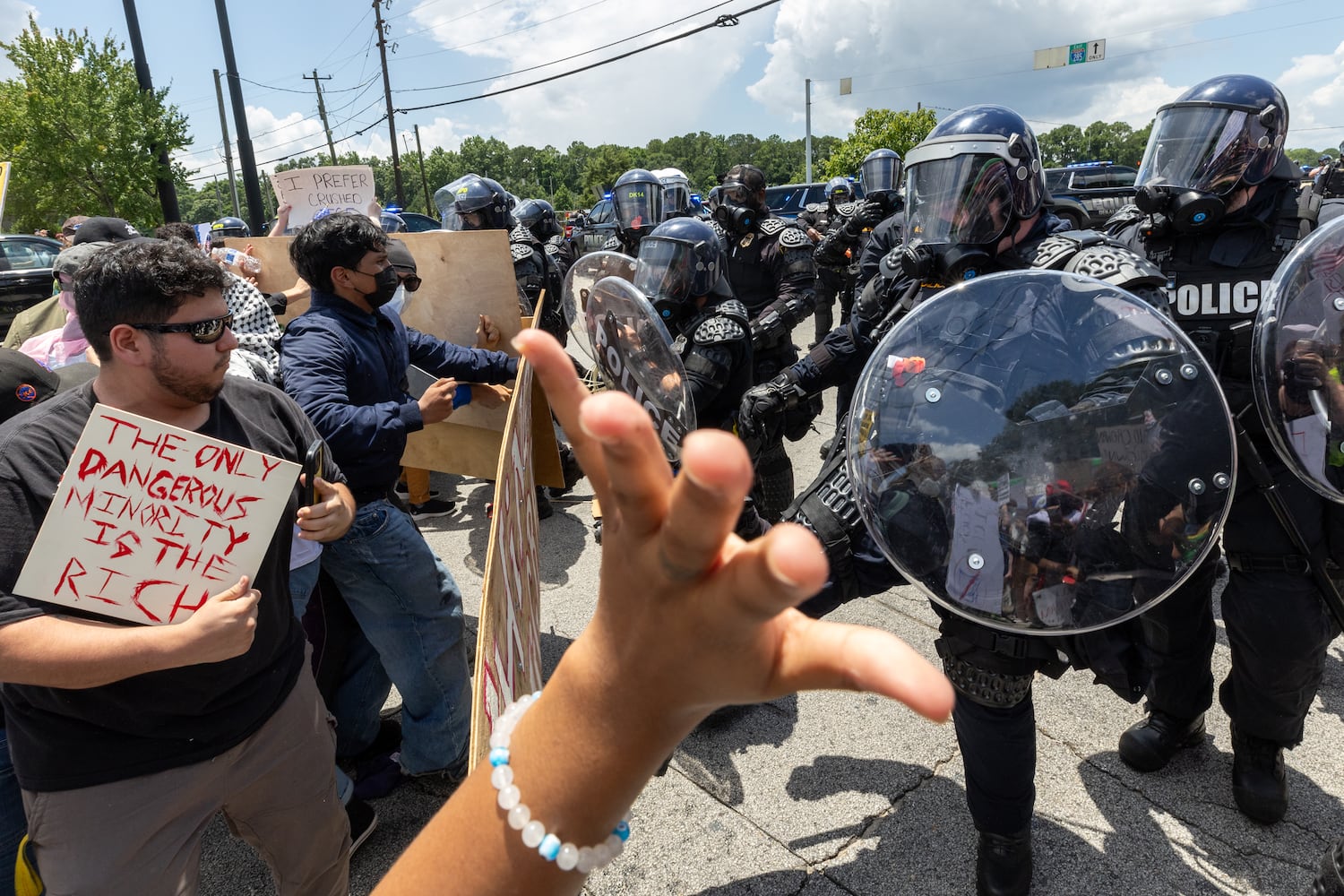 Police advance on demonstrators during a protest on ICE raids and deportation arrests on Chamblee Tucker Road in Atlanta on Saturday, June 14, 2025. (Arvin Temkar / AJC)