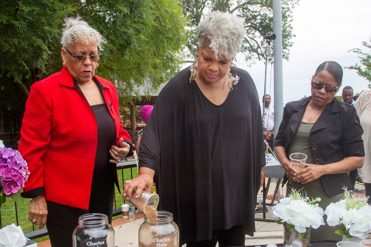 Charles Hale's family member Inger Williams pours dirt into a jar during the soil collection ceremony in Lawrenceville on Juneteenth, Saturday 19, 2021, in memory of Hale's 1911 lynching. Soil from the lynching site will be housed at the Legacy Museum, near the National Memorial for Peace and Justice in Montgomery, Alabama. (Photo: Steve Schaefer for The Atlanta Journal-Constitution)
