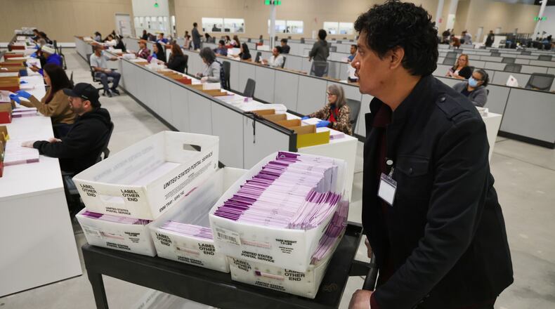 FILE - A worker pushes a cart of received mail ballots at the L.A. County Ballot Processing Center Nov. 4, 2025, in City of Industry, Calif. (AP Photo/Ethan Swope, File)