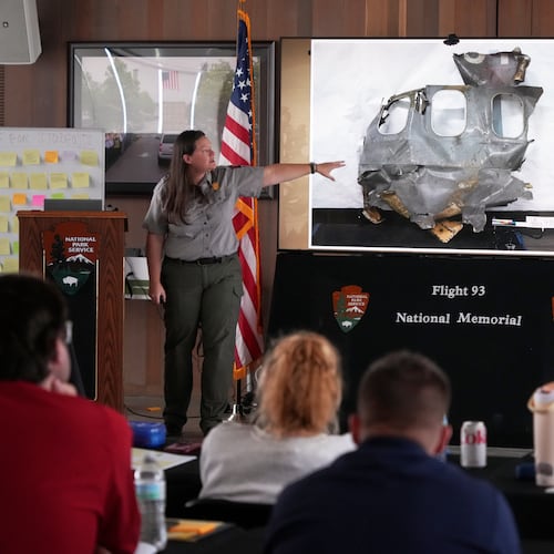 U.S. Park Ranger Betsy Keene, curator of National Parks of Western Pennsylvania, explains a slide showing a damaged part of United Flight 93 during an educators seminar at the Flight 93 National Memorial in Shanksville, Pa., Tuesday, June 23, 2026. (AP Photo/Gene J. Puskar)