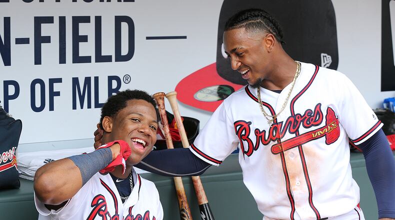 Atlanta Braves Ozzie Albies and Ronald Acuna Jr. celebrate in the dugout during a game earlier this month. The first-place Braves try to knock another digit off their magic number to clinch when they play the St. Louis Cardinals at home Monday night. Curtis Compton/ccompton@ajc.com