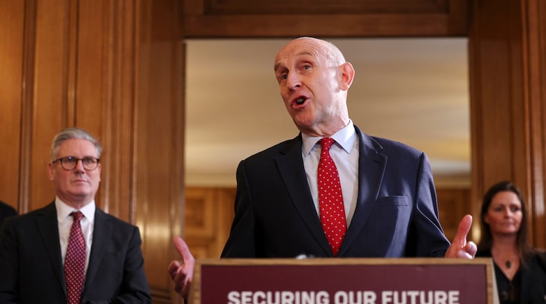 FILE - Britain's Prime Minister Keir Starmer, left, looks on as Defence Secretary John Healey speaks to apprentices and representatives in the defence industry, during a careers fair inside 10 Downing Street in central London, Monday March 3, 2025. (Adrian Dennis/Pool via AP, File)