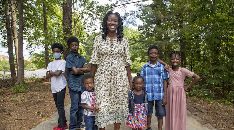 Marissa Anderson balances working at home as a 4th grade teacher at Hawthorne Elementary School with being a mom to Mark (left), Michael (second from left), Madison (right), Jacob (second from right), Isaac (third from left) and Isabella (third from right). (ALYSSA POINTER / ALYSSA.POINTER@AJC.COM)